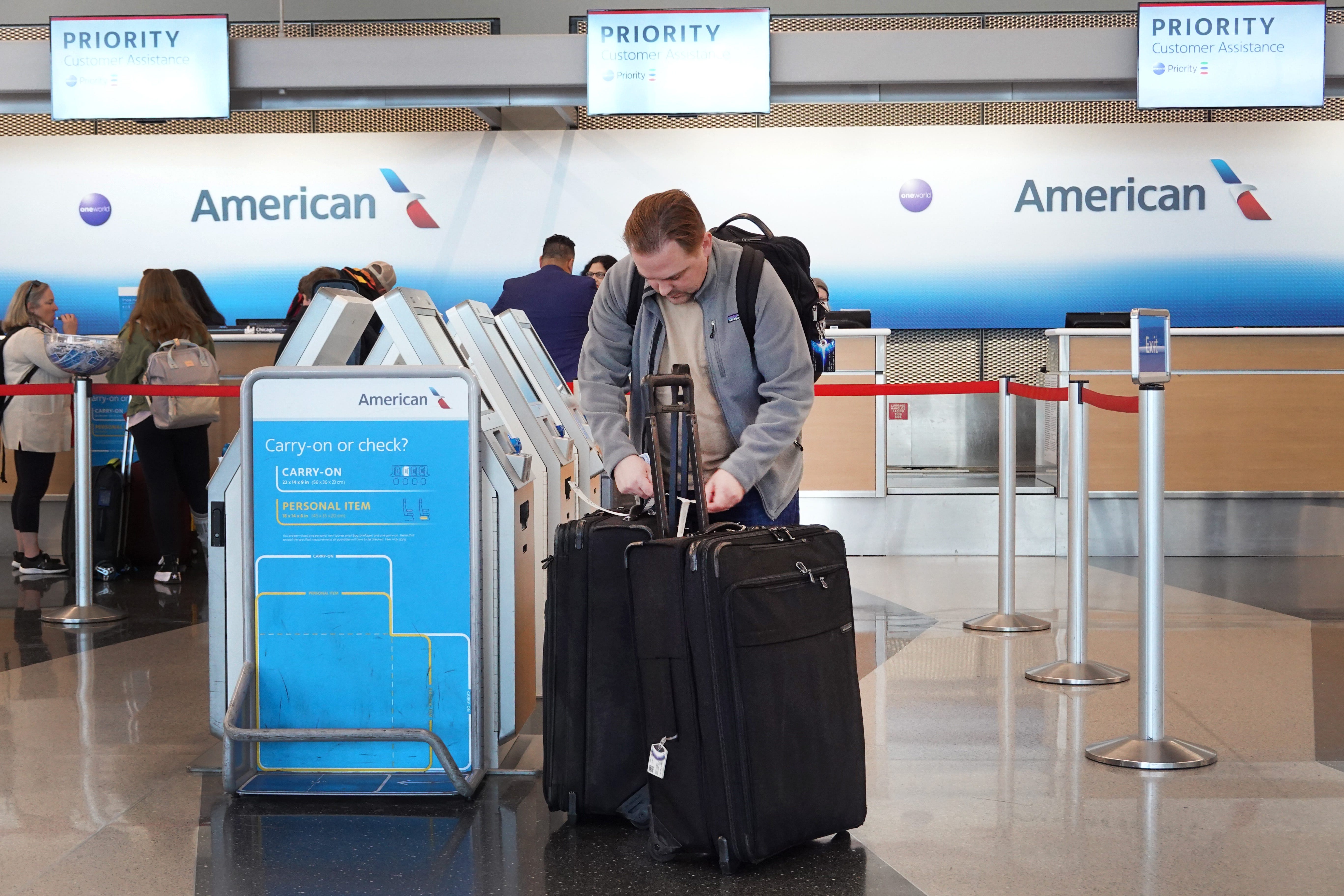 Passagiere checken am 11. Oktober 2022 am O'Hare International Airport in Chicago, Illinois, für einen American Airlines-Flug ein.