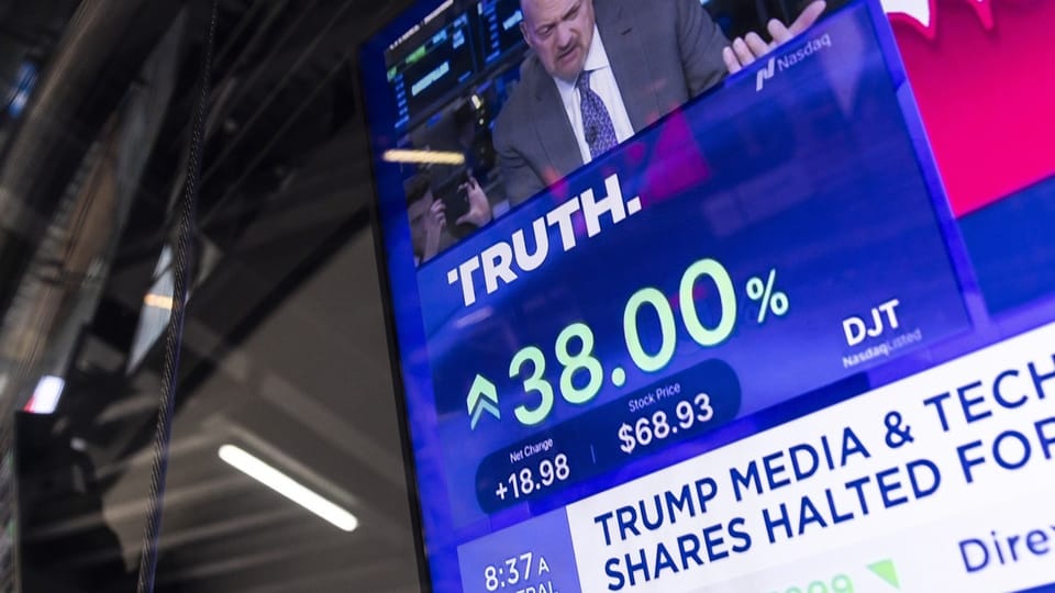 A television screen shows the stock price of Trump Media and Technology Group.