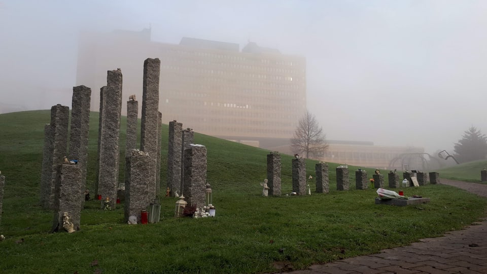 The park in front of the cantonal hospital.  You can see stone pillars with candles and souvenirs of deceased children. 