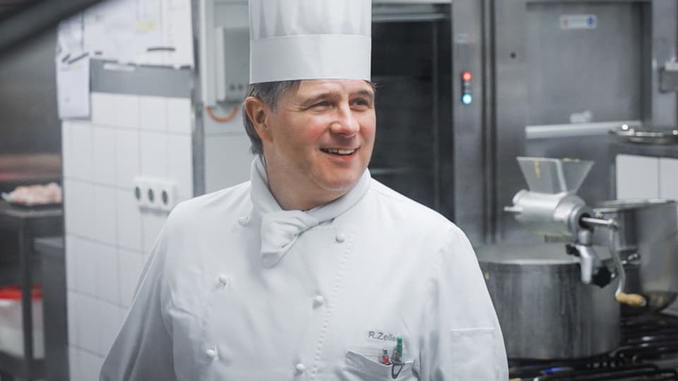 Robert Zeller with a chef's hat in the kitchen.