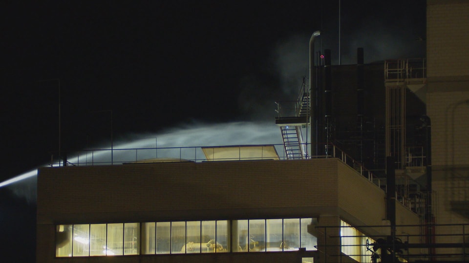 A jet of water hits the CABB production facility building.