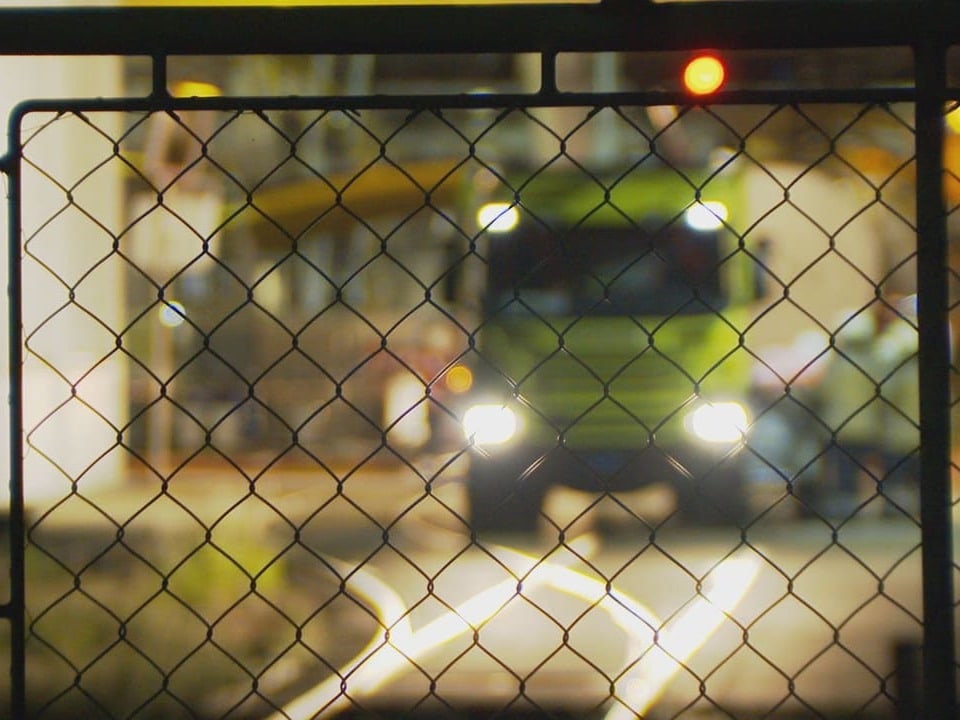An emergency vehicle behind a grille.