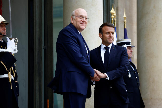 French President Emmanuel Macron greets Lebanon's caretaker Prime Minister Najib Mikati as he arrives for a meeting at the Elysée Palace in Paris on April 19, 2024. 