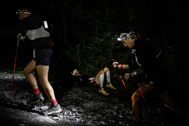 An athlete sleeps on the side of the path during the 20th edition of the Ultra Trail du Mont-Blanc (UTMB), a 171 km race crossing France, Italy and Switzerland.  In Chamonix (Haute-Savoie), September 1, 2023. 