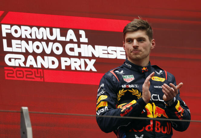 Max Verstappen celebrates his victory on the podium of the Chinese Grand Prix on April 21, 2024 in Shanghai.