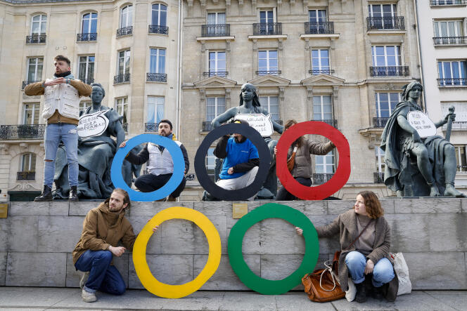 Activists from the collective The Reverse of the Medal in front of the Musée d'Orsay, in Paris, on March 24, 2024, to protest against the widening inequalities that the Olympic Games would encourage in the capital.