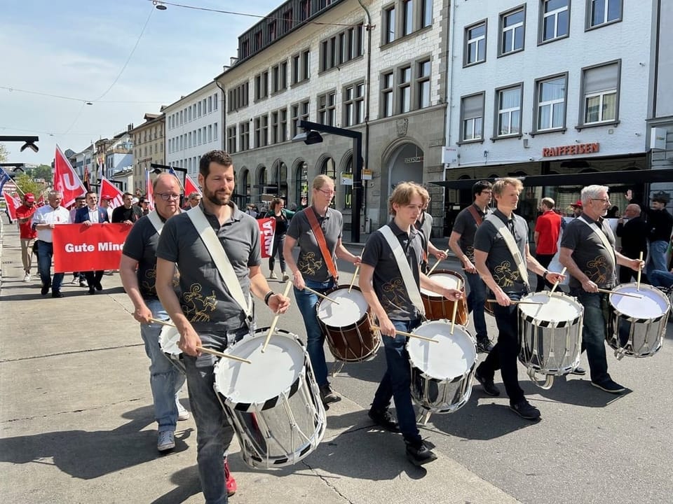 Drums lead a procession.
