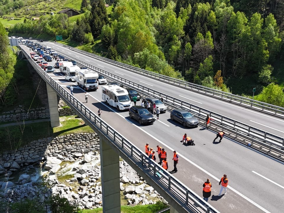 Aerial view of a highway bridge with traffic jams and emergency services at an accident.