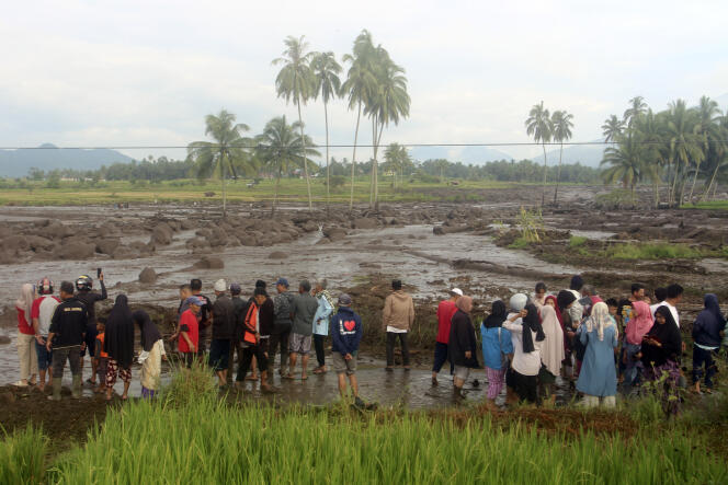 People inspect an area affected by the flash flood that killed several people in Agam, West Sumatra, Indonesia, Sunday, May 12, 2024. 