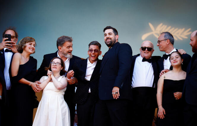 The team of the film “Un p’tit truc en plus” poses on the red carpet at the 77th Cannes Film Festival, May 22, 2024. 