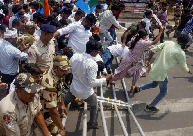Members of the National Students' Union of India break through barricades during a protest over education and unemployment, in Bhubaneswar on March 13, 2024.
