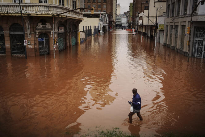 A man walks through an area flooded by heavy rains in Porto Alegre, Brazil, Friday, May 3, 2024.