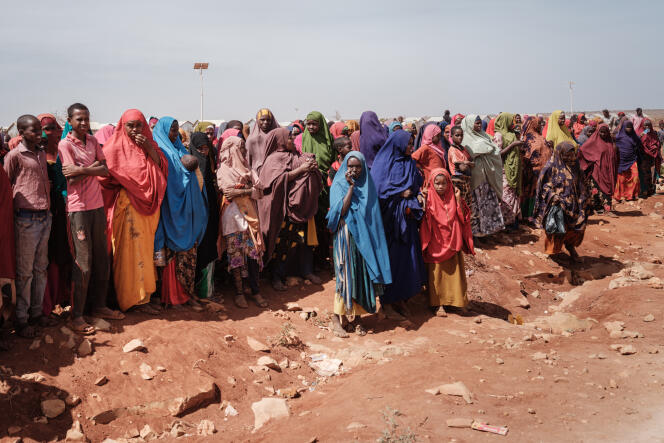 People wait for food distributions and care at a camp for internally displaced people in Baidoa, Somalia, February 14, 2022.