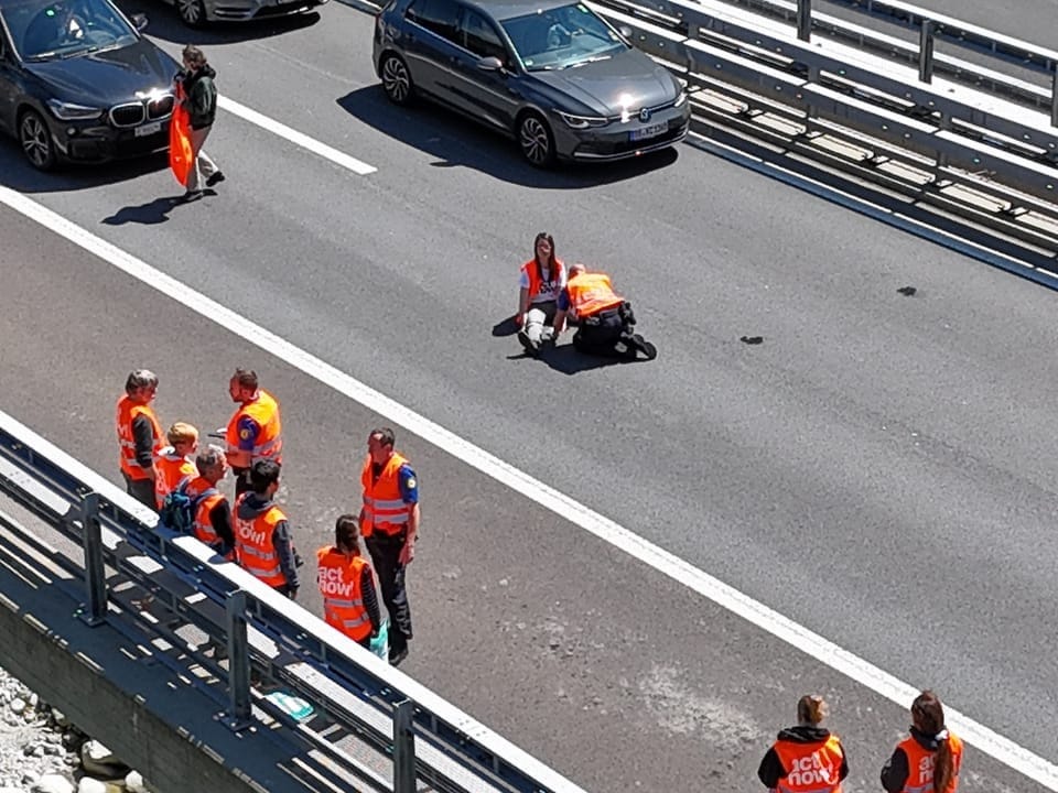 Rescue workers in orange vests on the highway during an operation