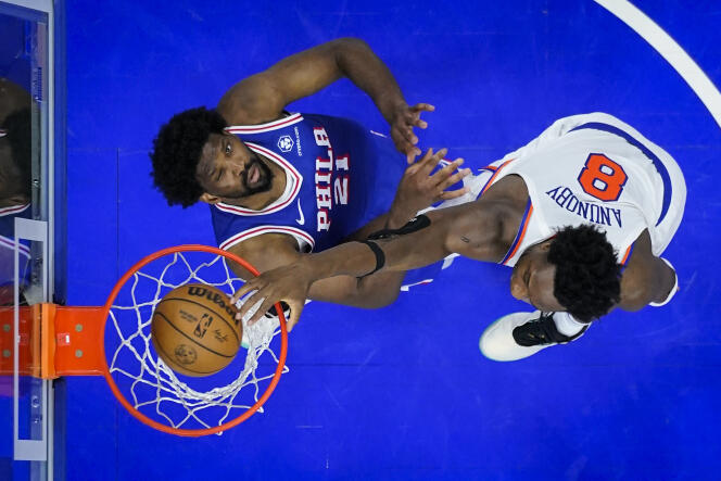 OG Anunoby of the New York Knicks dunks over Joel Embiid of the Philadelphia 76ers during their NBA playoff game, Thursday, May 2, 2024, in Philadelphia. 