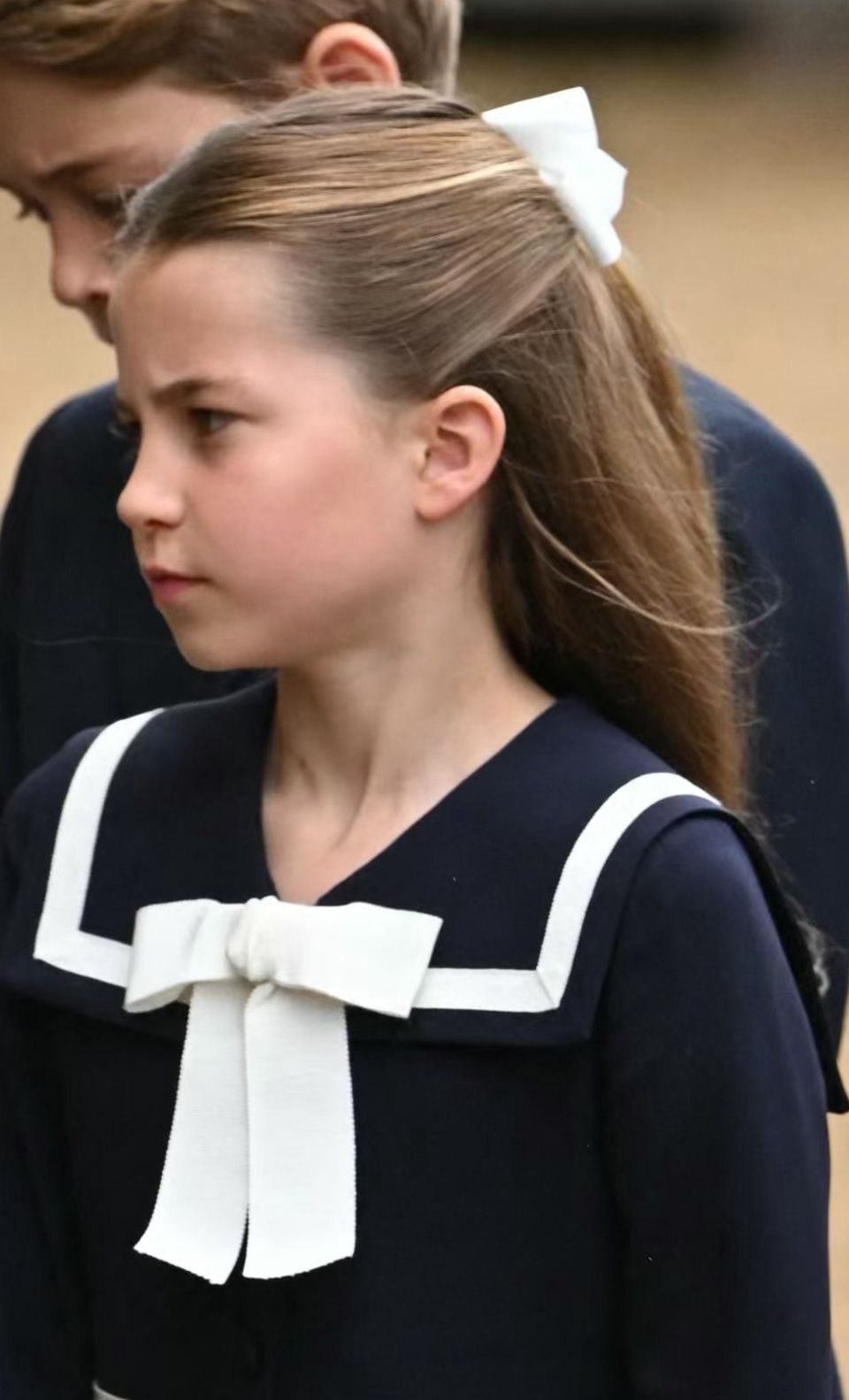 Two bows adorn Princess Charlotte’s head and dress. 