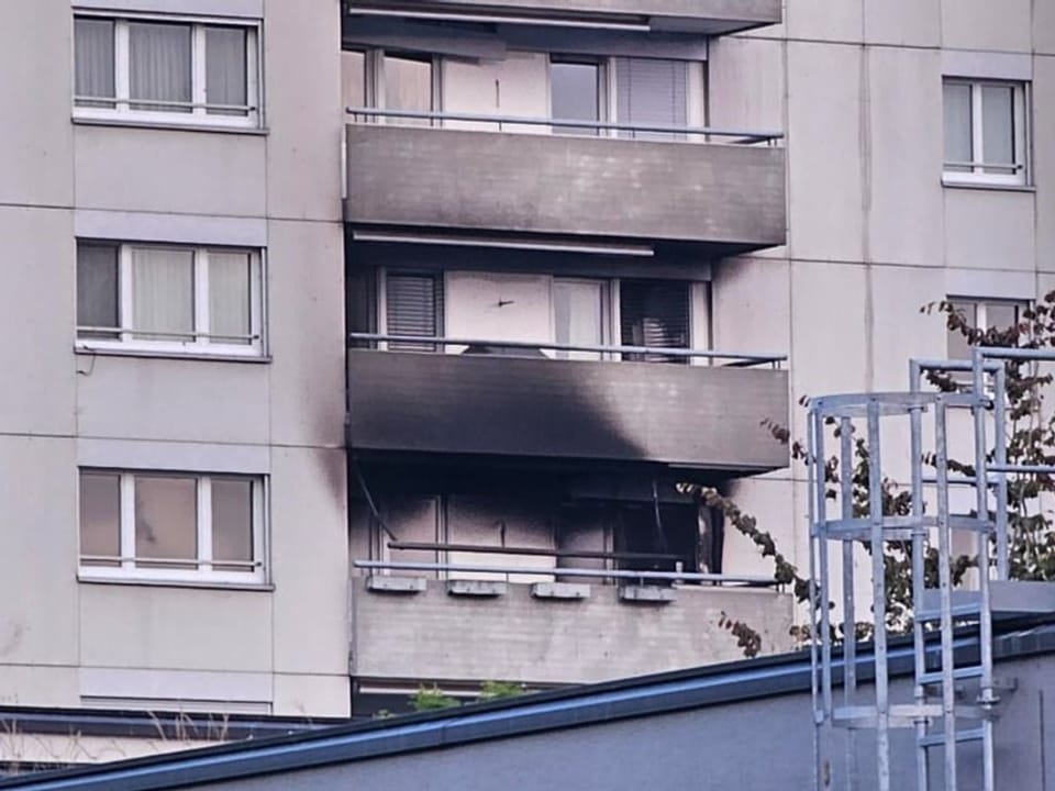 Balcony of high-rise building with burn marks.